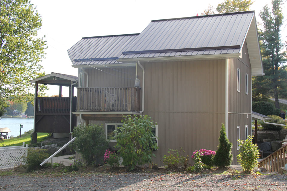 Residential - grey house with vertical siding - left side view