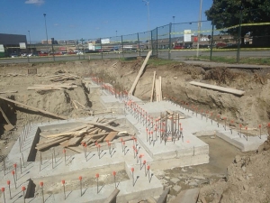 Commercial project - 2140 CarlingRd. - rebar and and rebar caps, footings, trenching, cast in place concrete formwork, site fencing, footings with rebar for walls