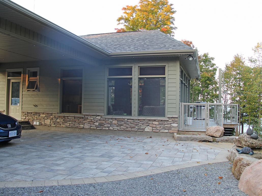 Residential project - green stone house wirth horizontal siding - breezeway porch